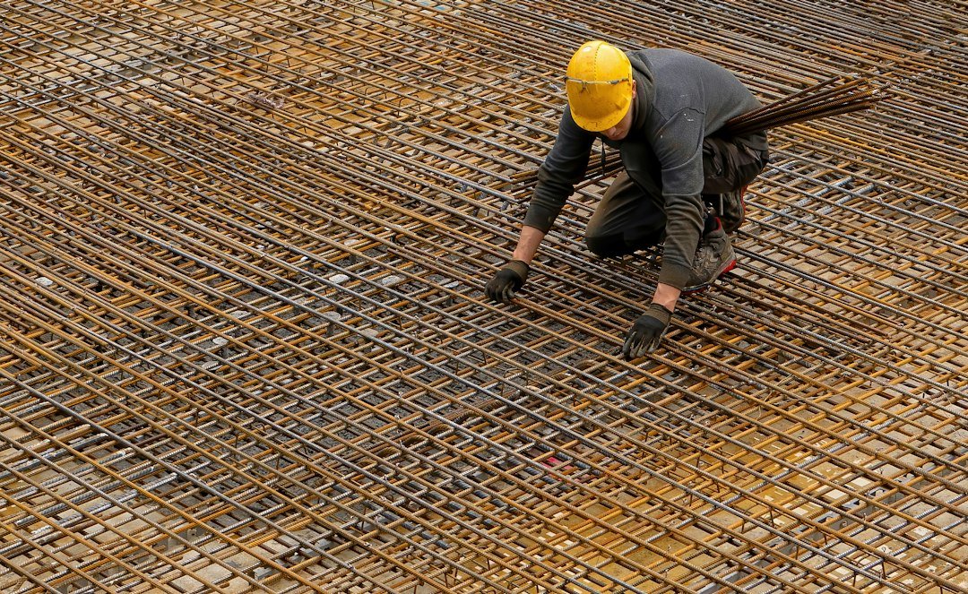 Construction worker handling reinforcing steel